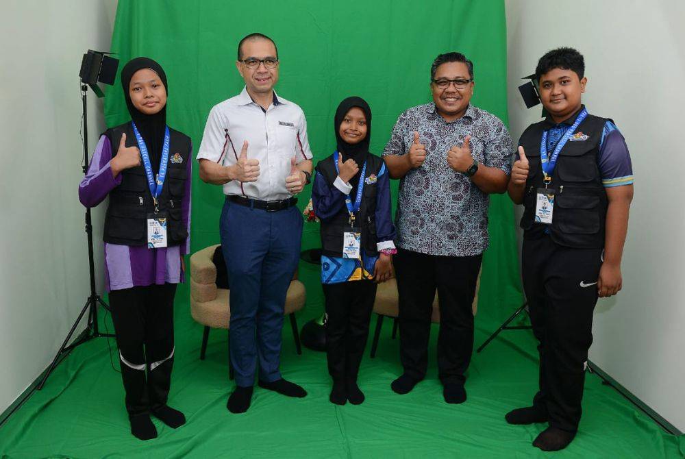 Cairil Irwan (dua dari kiri) dan Zamri (dua dari kanan) bergambar bersama kru TV PSS SK Permatang Pasir selepas perasmian Studio TV PSS sekolah itu.