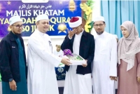 Ahmad Fikri (tengah) ditemani ibu bapa menerima penghargaan daripada Najmuddin (dua dari kiri).