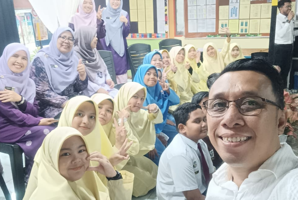 Mior Shahril merakam foto kenangan bersama anak murid.