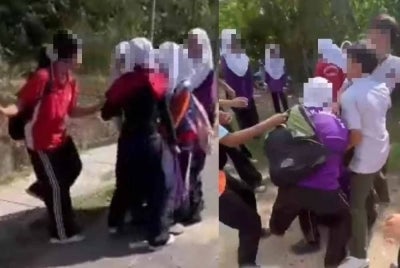 Tangkap layar video tular memaparkan seorang pelajar dipukul oleh sekumpulan pelajar lain di Kota Kinabalu.