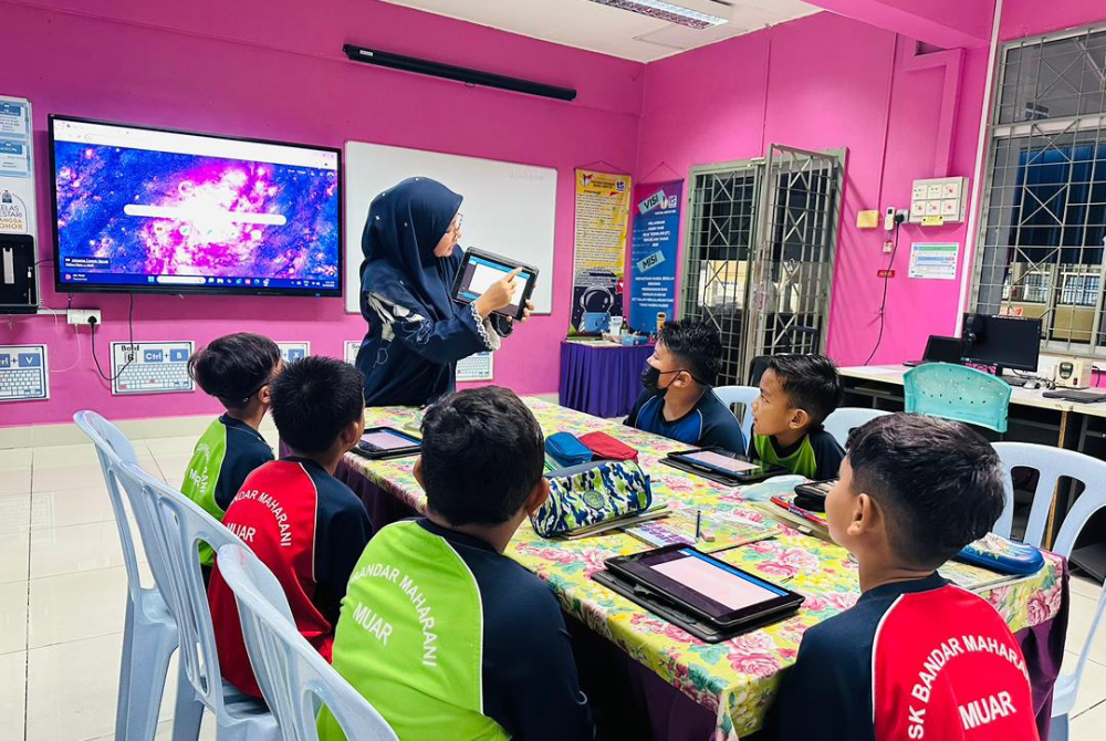 Siti Zubaidah mengaplikasikan teknologi sebagai alat pengajaran dalam kelas.