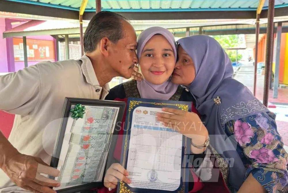 Nur Aina Najwa (tengah) dicium ibu bapanya selepas meraih keputusan cemerlang STPM 2025.