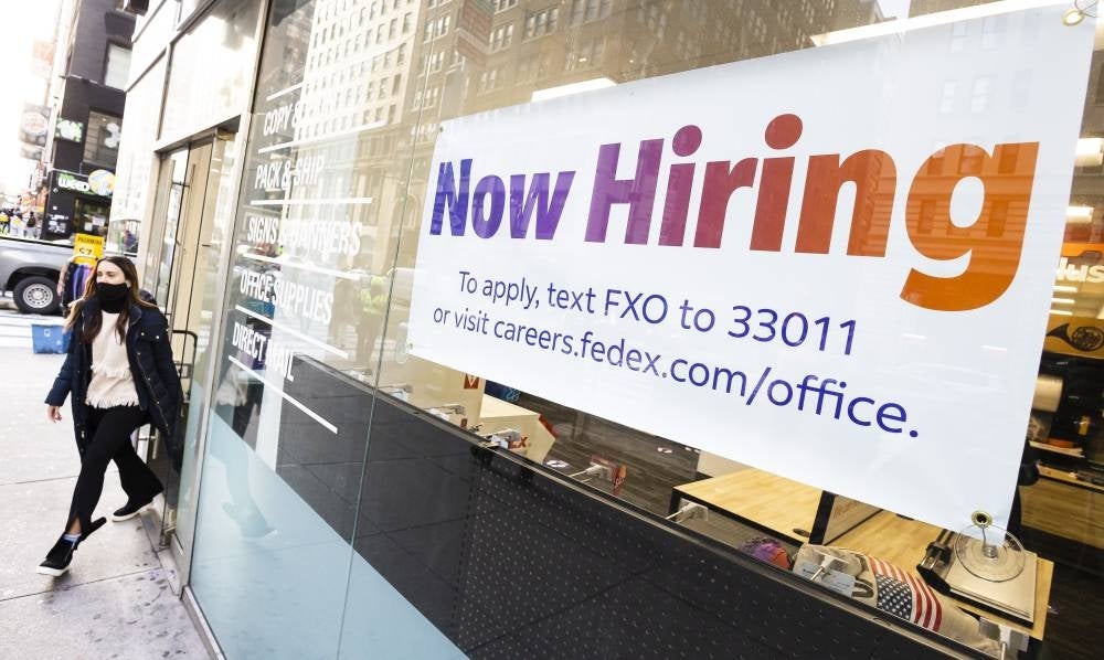 A sign advertising job openings in a store window in New York, New York, USA, Jan 4, 2022. The United States' Department of Labor reported that 4.5 million people quit their jobs in November 2021 and that employers posted 10.6 million job openings during that same time. (Source: EPA/JUSTIN LANE)