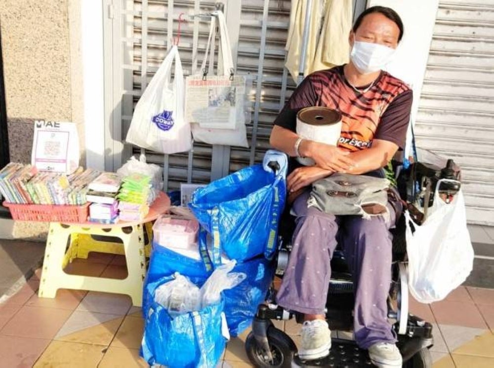 Koh Lee Peng sells packets of tissues and other sundry items to make ends meet. -- Photo by MyKMU