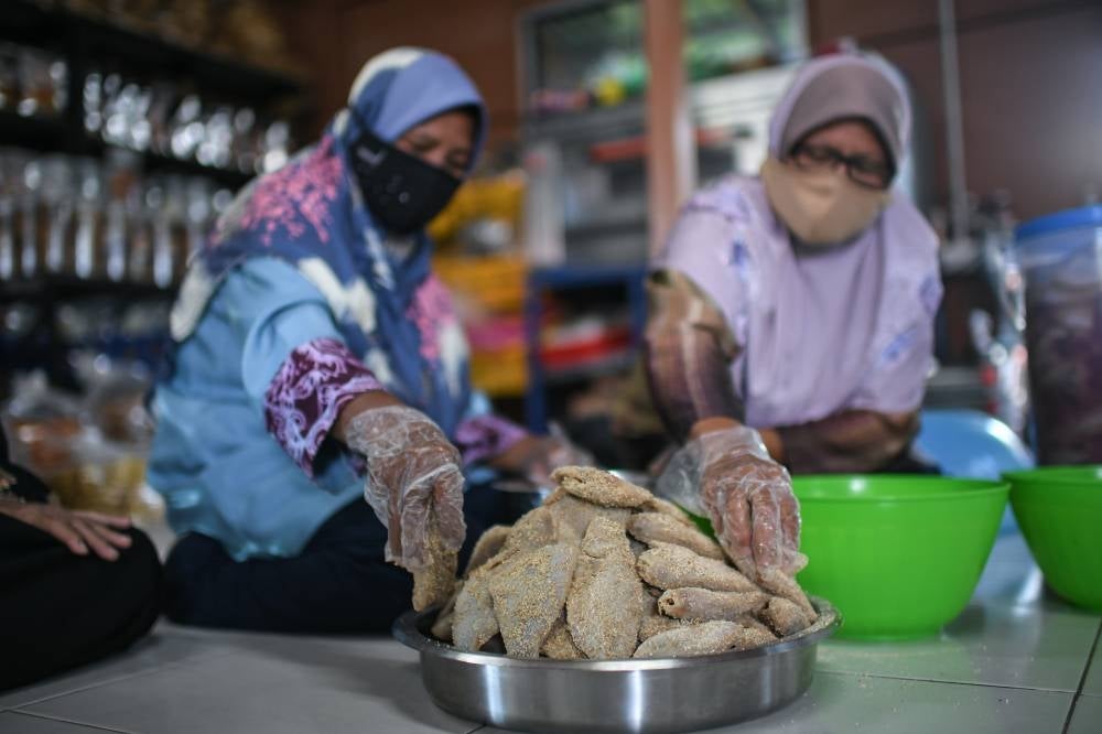 Workers at the community centre. - BERNAMA