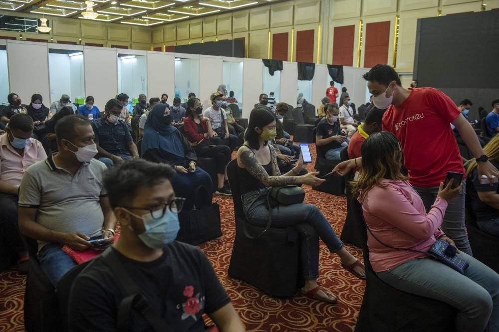Vaccine booster shot receivers waiting at the observation area at the Kuala Lumpur World Trade Centre PPV on Jan 15. - Photo by Bernama.