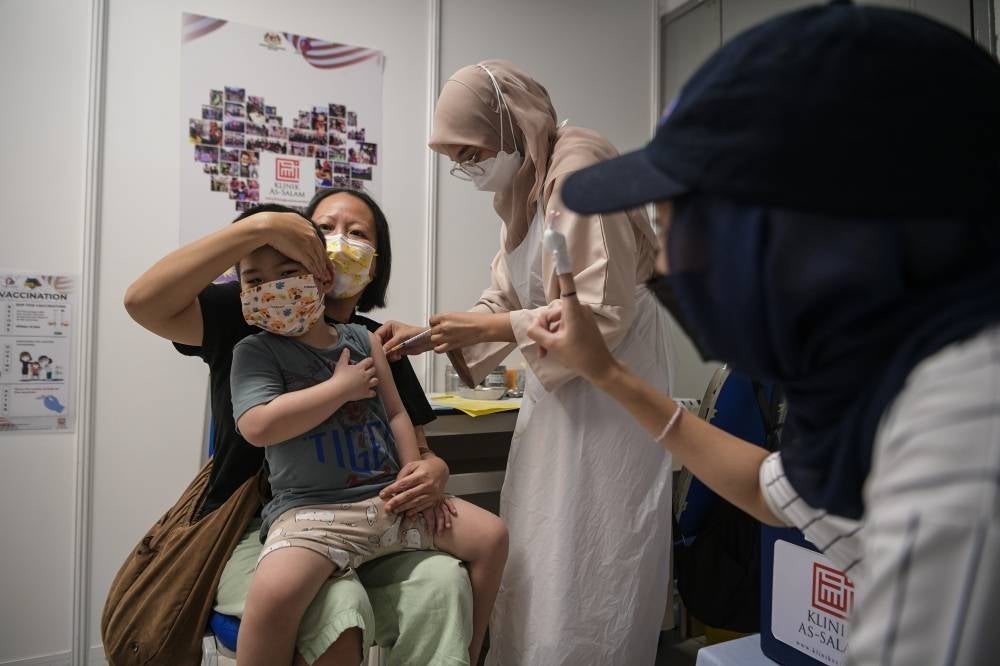 A boy getting his Covid-19 vaccine during the National Covid-19 Immunisation Programme for Kids (PICKids) at Axiata Arena in Bukit Jalil, today. - BERNAMA