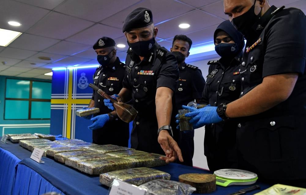 Timur Laut district police chief, ACP Soffian Santong showing the drugs worth RM61,847.50 which were seized in a series of raids conducted in Air Itam on Feb 6, 2022. - BERNAMA
