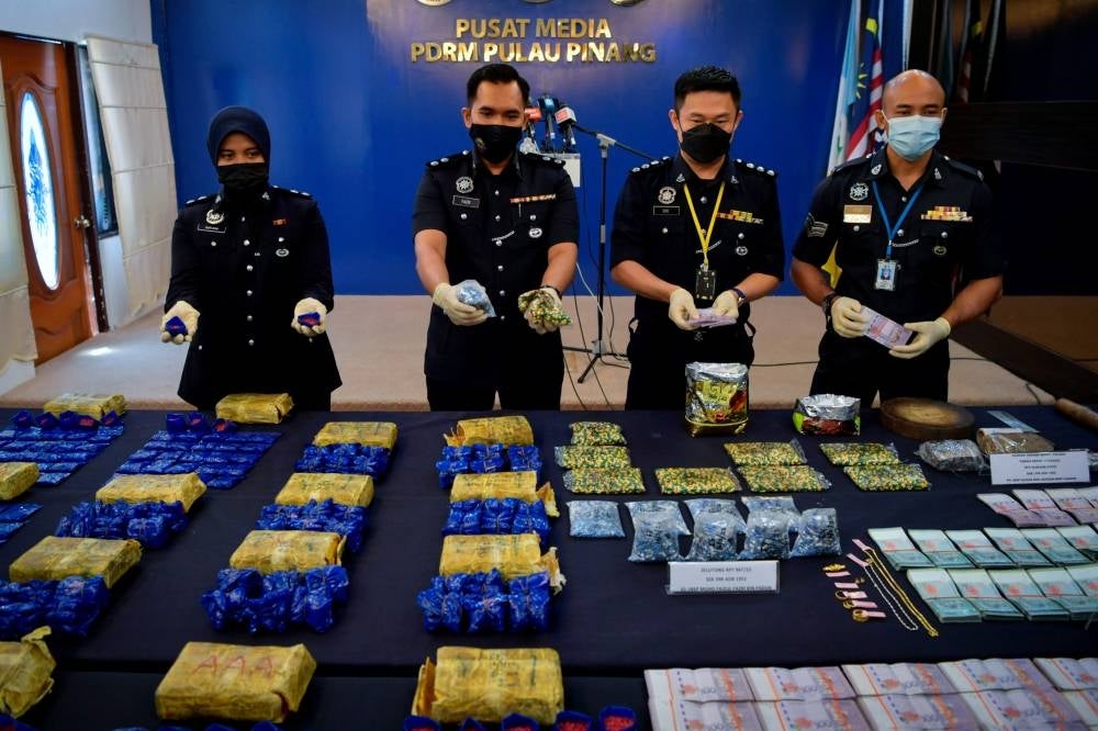 Penang police chief Datuk Mohd Shuhaily Mohd Zain showing various drugs seized by police in two raids around George Town. - BERNAMA 