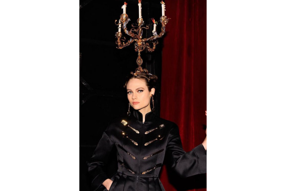 Clad in black, the model sported a candelabrum on her head.