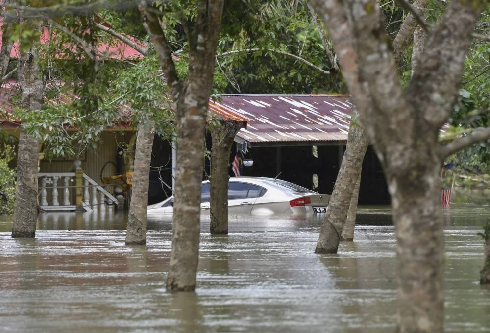 A car submerged in floodwaters in Kampung Tersang, Rantau Panjang on March 3, 2022. - BERNAMA
