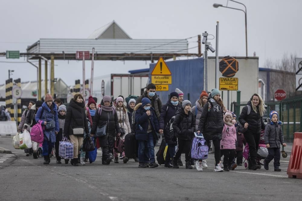 Refugees from Ukraine are pictured after crossing the Ukrainian-Polish border in Korczowa on March 02, 2022. -AFP
