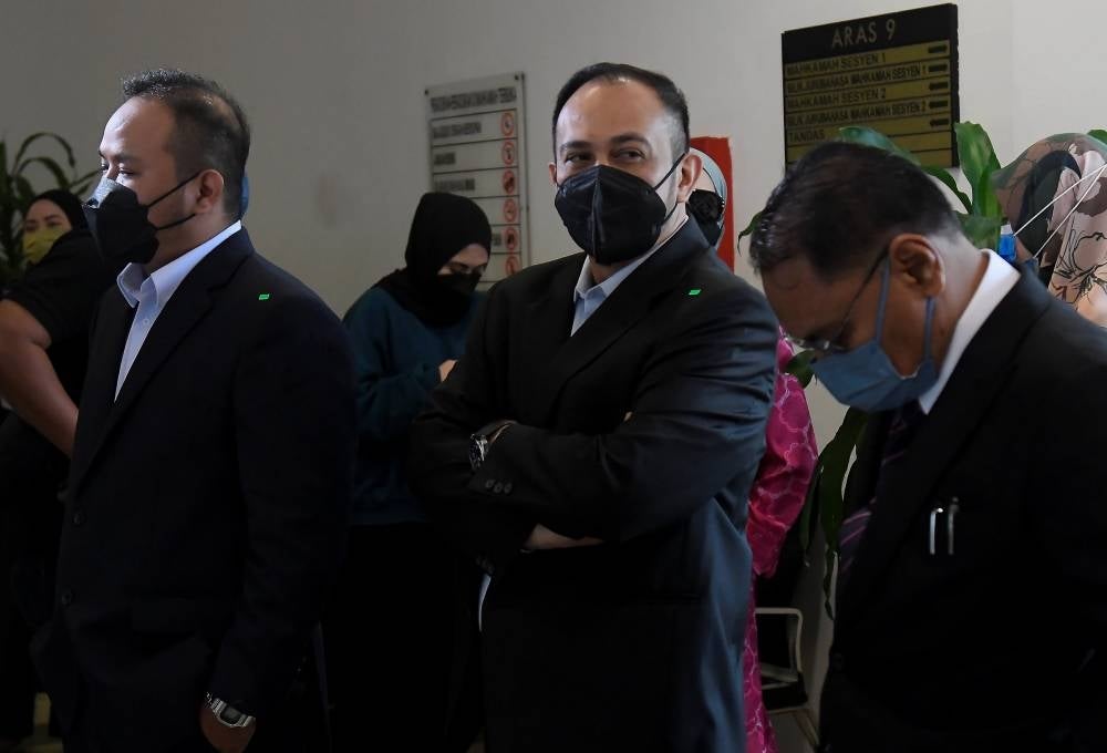 Two out of four businessmen, Datuk Ab Aziz Abdullah, 44, (middle) and Abu Yazid Mohd, 38, (left) charged with money laundering involving millions of ringgit in connection with the issuance of Temporary Employment Visit Passes (PLKS). - BERNAMA