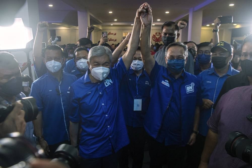BN chairman Ahmad Zahid Hamidi (centre left) along with Johor Menteri Besar Hasni Mohammad, (centre right) was cheered on by supporters when they arrived at the BN command centre in Johor Bahru on March 12. - Bernama Photo