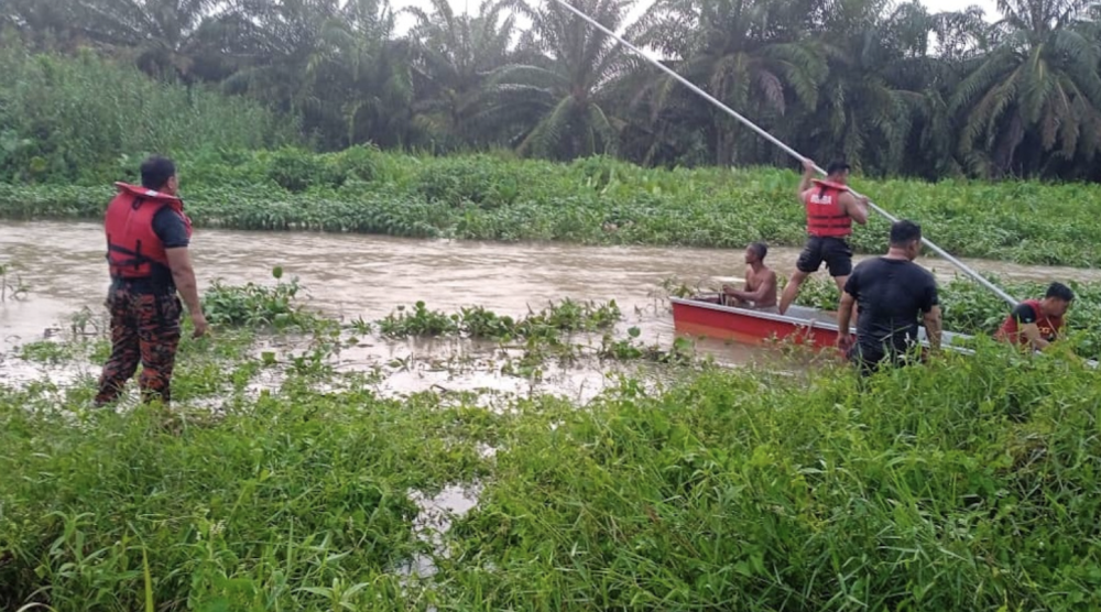 Fire and Rescue personnel conducting a search at a canal at Kilometre 32 Jalan Bota Kiri - Ulu Dedap near Kampung Gajah. - Photo credit: Fire and Rescue Department