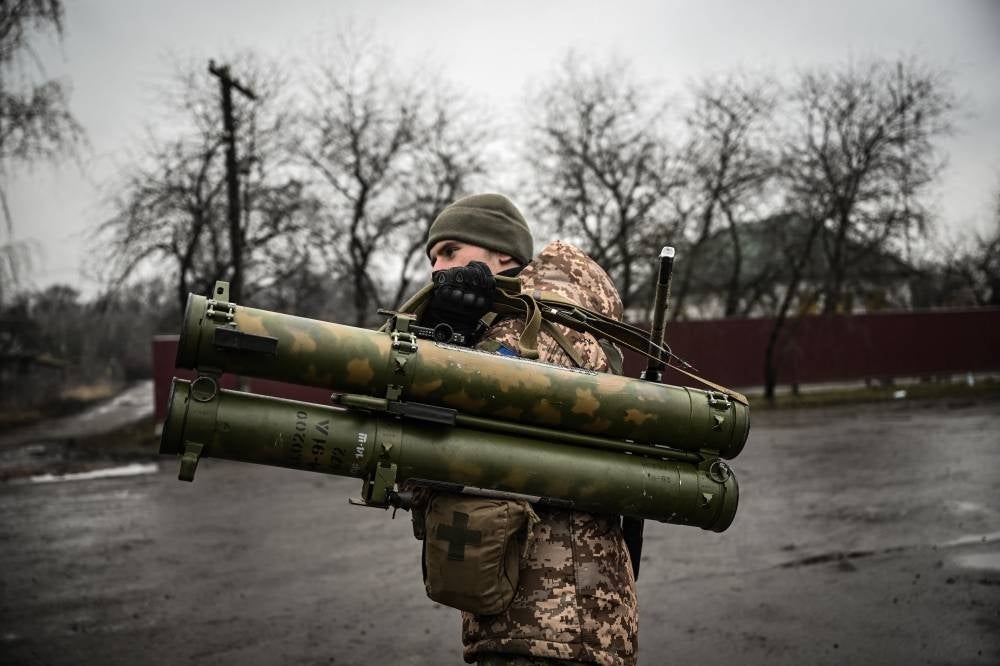Ukrainian soldier holds an anti-tank launcher at a frontline, northeast of Kyiv on March 3, 2022. - AFP