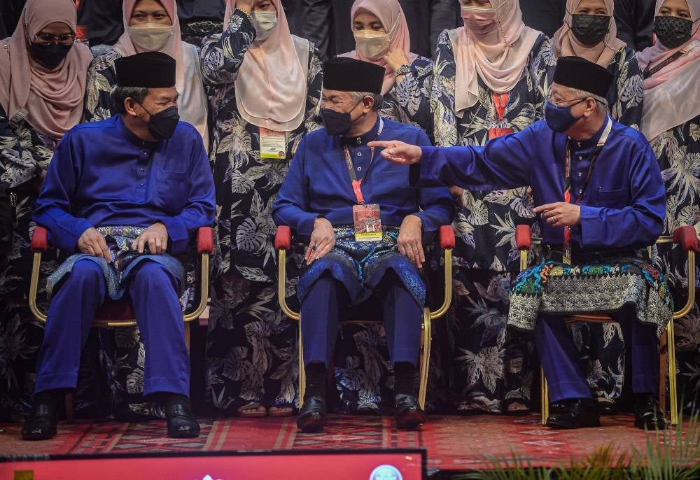 Umno president Ahmad Zahid Hamidi (centre) along with Umno deputy president Mohamad Hasan (left) and Umno vice president Ismail Sabri Yaakob (right) on stage together during the party's annual general assembly at the World Trade Centre. - Bernama Photo