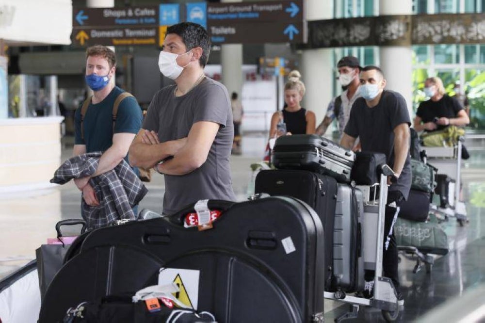 Travellers arrive at Ngurah Rai International Airport in Bali, Indonesia, on March 7, 2022. - EPA