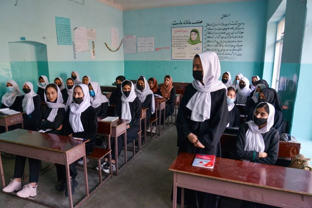 Girls attend a class after their school reopening in Kabul on March 23, 2022. The Taliban ordered girls' secondary schools in Afghanistan to shut on March 23 just hours after they reopened, an official confirmed, sparking confusion and heartbreak over the policy reversal by the hardline Islamist group. - AFP