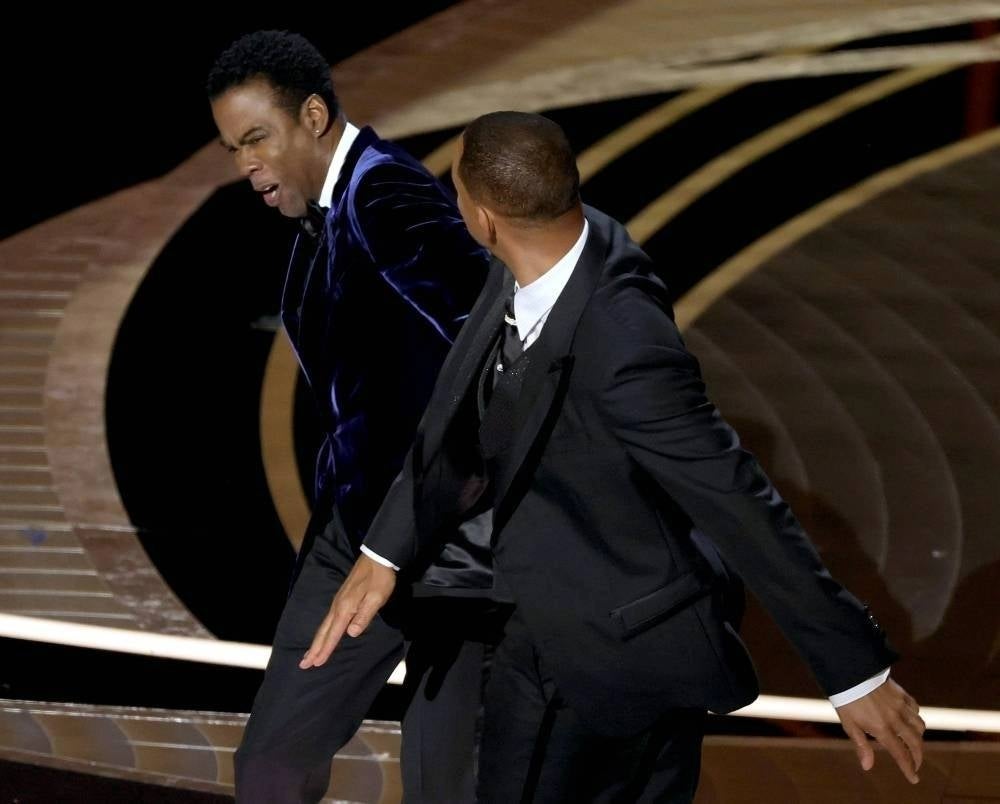 Chris Rock and Will Smith are seen onstage during the 94th Annual Academy Awards at Dolby Theatre on March 27, 2022 in Hollywood, California. - AFP