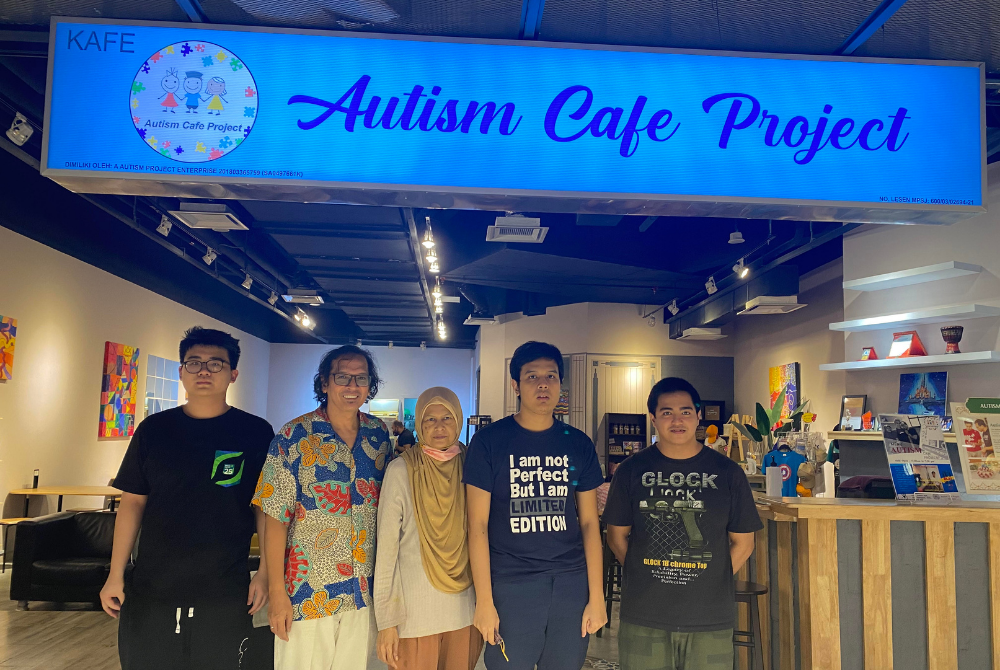 Mohd Adli Yahya (second from the left), 57, founder of Autism Cafe Project and his wife next to him, Nozilan Muhamad, also 57. The pair poses in front of Autism Cafe Project with their son and employees at Da Men mall, USJ1.