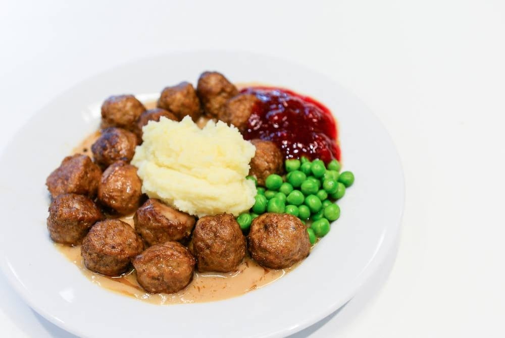 A traditional Swedish dish, Swedish meatballs with mashed potatoes, peas, lingonberry jam and cream sauce. - AFP