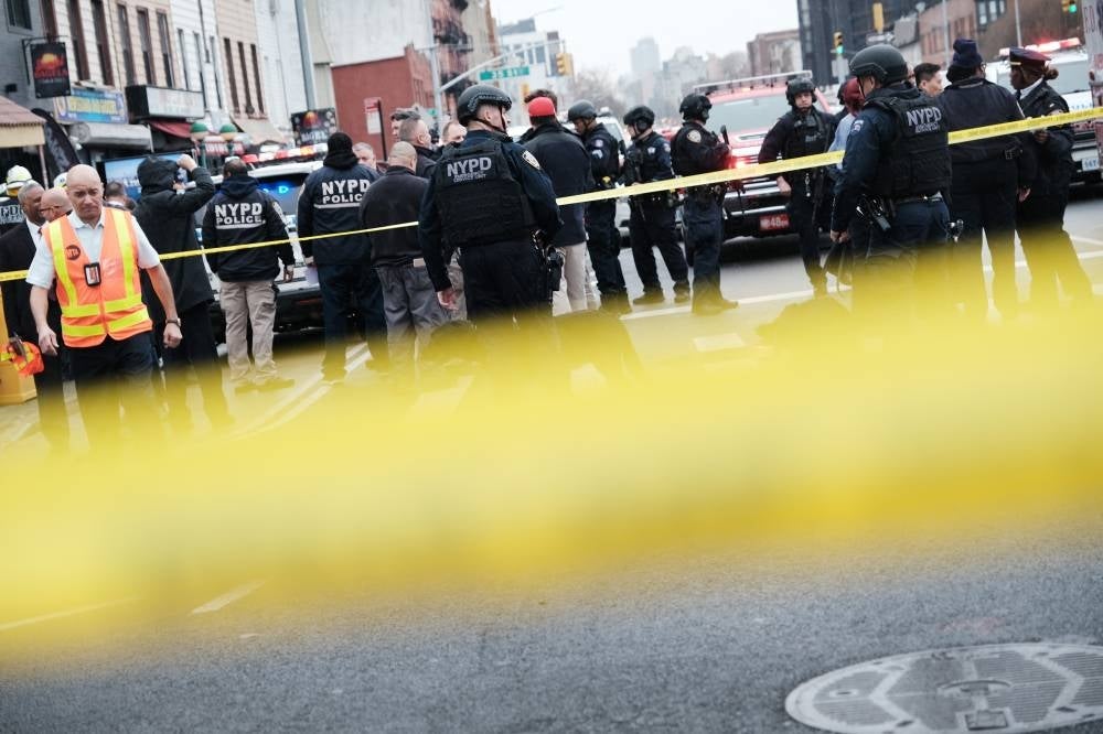 Police and emergency responders gather at the site of a reported shooting of multiple people outside of the 36 St subway station on April 12, 2022 in the Brooklyn borough of New York City. - AFP