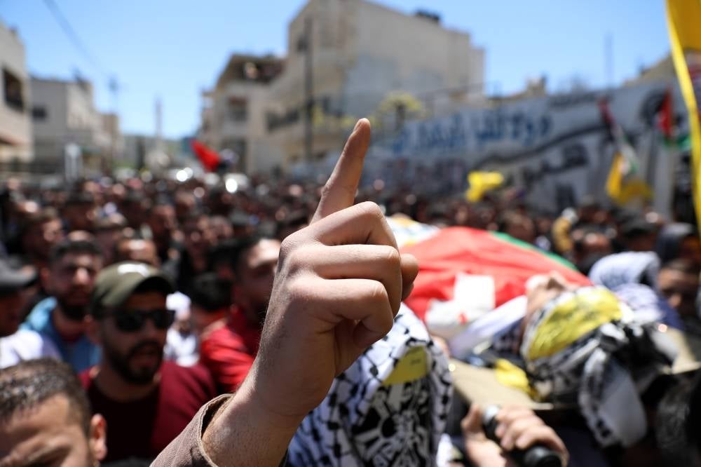 epaselect epa09889627 Palestinian mourners carry the body of Palestinian Qusai Al Hamamrah during his funeral in the West Bank town of Husan near Bethlehem, 14 April 2022. According to the Palestinian Health Ministry, the 14-year-old Qusai Al Hamamrah was shot and killed by Israeli forces on the evening of 13 April, during an incident between Palestinians and Israeli security forces in the town of Husan, near Bethlehem. EPA/ABED AL HASHLAMOUN