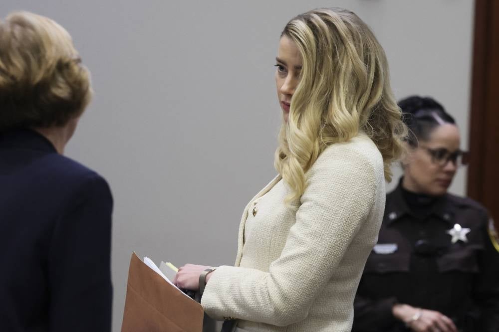 US actress Amber Heard looks on at the end of the second day of her ex-husband Johnny Depp's testimony during his defamation trial against her, at the Fairfax County Circuit Courthouse in Fairfax, Virginia, April 20, 2022. - AFP