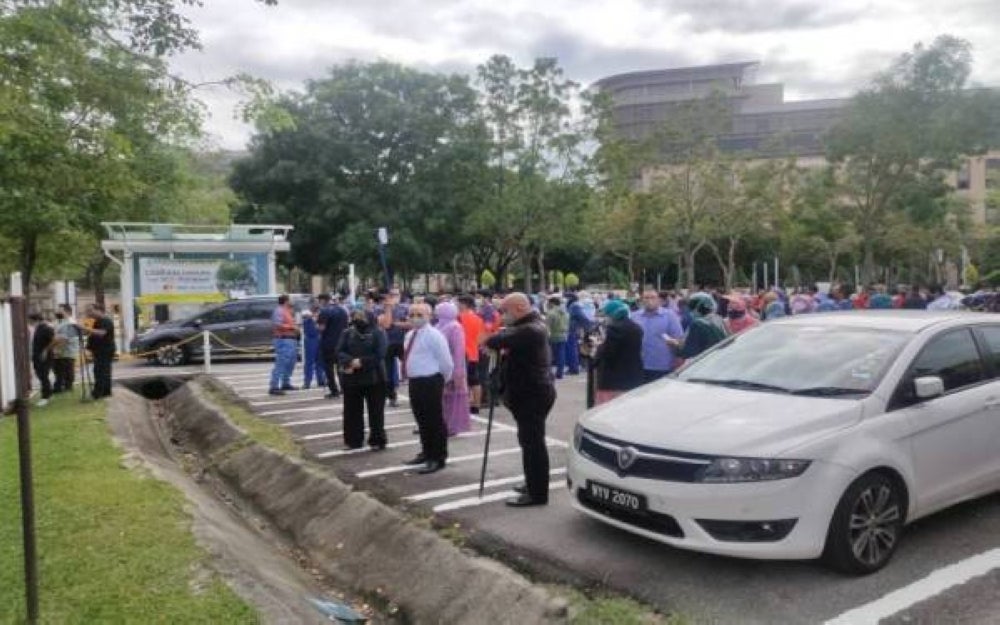 People standing outside the Federal Territories Building in Putrajaya following aftershocks from an earthquake with a magnitude of 6.2 in Bukit Tinggi, Indonesia that can be felt all the way to Peninsular Malaysia.