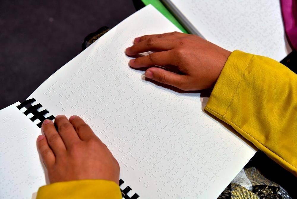 People with Disabilities read surahs using the Braille Al-Quran Mashaf at the Malaysian Braille Al-Quran Mashaf Launching Ceremony at the National Level 1443H/2022 at the Auditorium of the Putrajaya Islamic Complex today. - BERNAMA