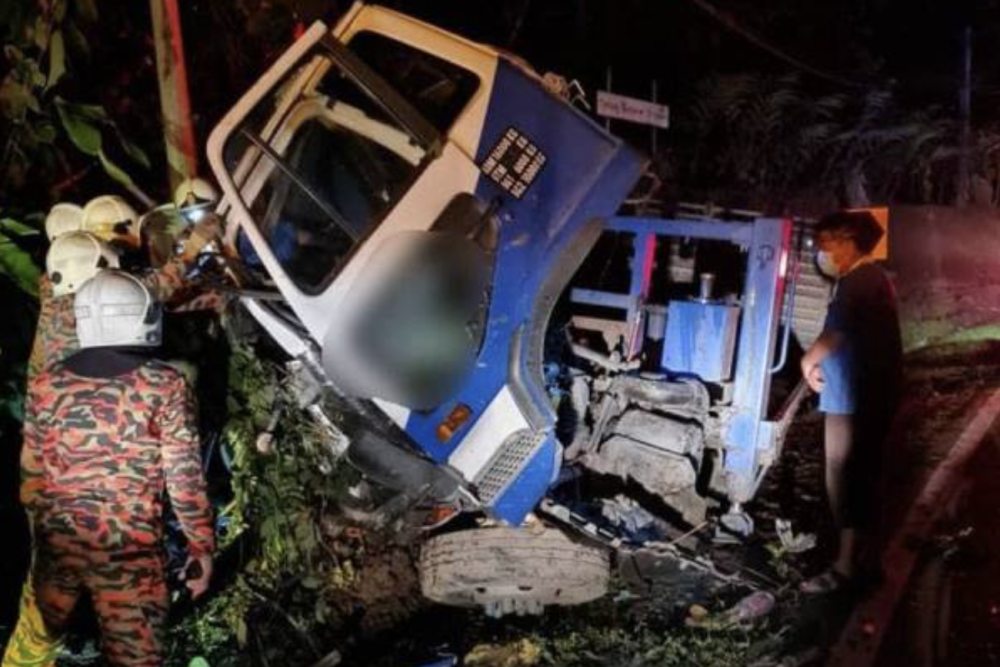 Firefighters extracting the victims trapped inside the lorry after the accident at KM42, Jalan Kimanis-Keningau, Papar, on March 31, 2021.