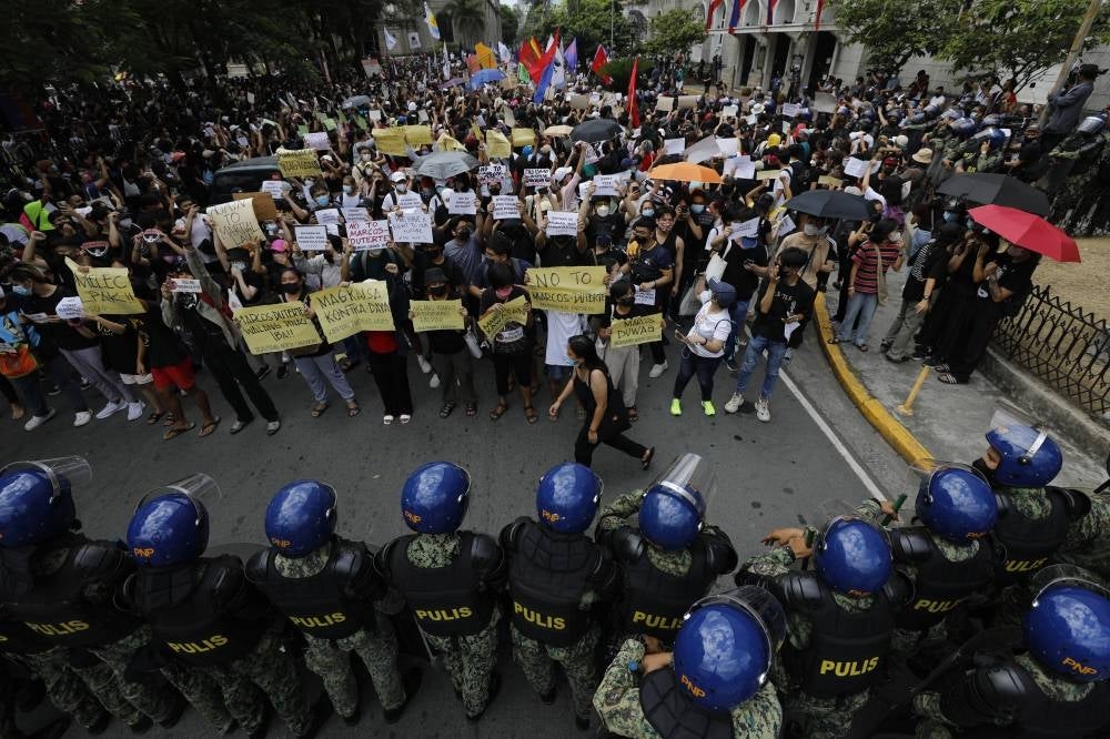 Filipino protestors stage a demonstration calling out against Ferdinand 'Bongbong' Marcos winning the presidency, in front of the Commission on Elections (Comelec) headquarters, in Manila, Philippines, May 10, 2022. (EPA/FRANCIS R. MALASIG)