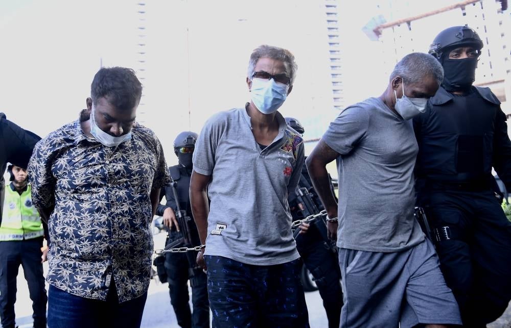 Friends T. Muniswaran, 49, S. Katharavello, 52, and Mohd Zulbihar Ali Khan Kamaldin, 48, were charged at the Kuala Lumpur magistrate’s court with murdering a man at a hotel in Bukit Bintang. - BERNAMA