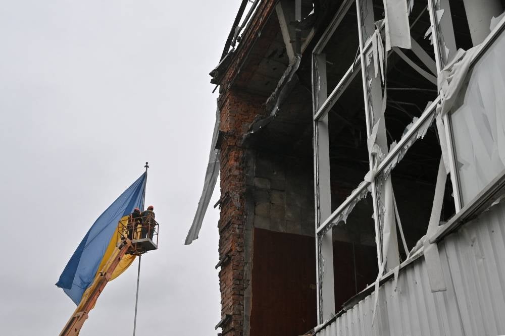 Ukrainian flag on a flagpole at a destroyed building in the centre of Makariv, Kyiv region, on April 10, 2022, during the Russian invasion of Ukraine.- AFP
