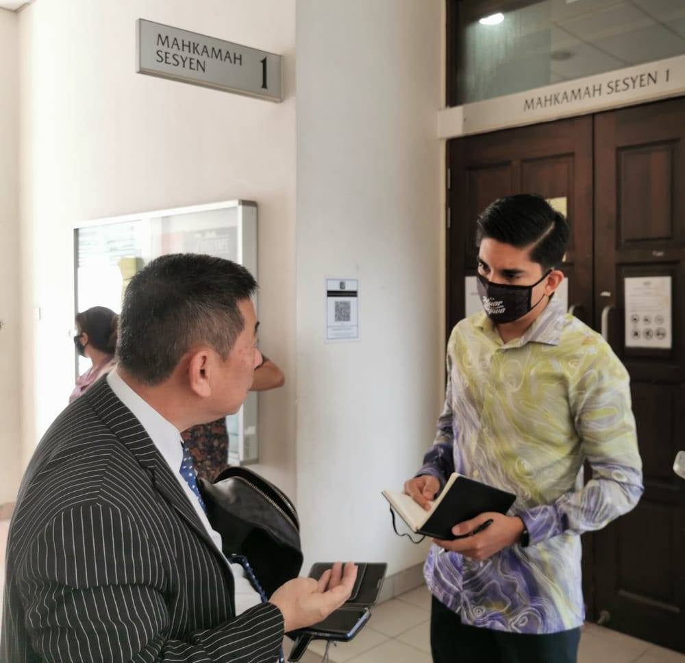 Syed Saddiq Syed Abdul Rahman (left) outside of the courtroom during the case mention of nasyid singer and composer Yasin who was charged with cultivating and trafficking cannabis, at the Petaling Jaya Courts Complex. - Photo by KOUSALYA SELVAM