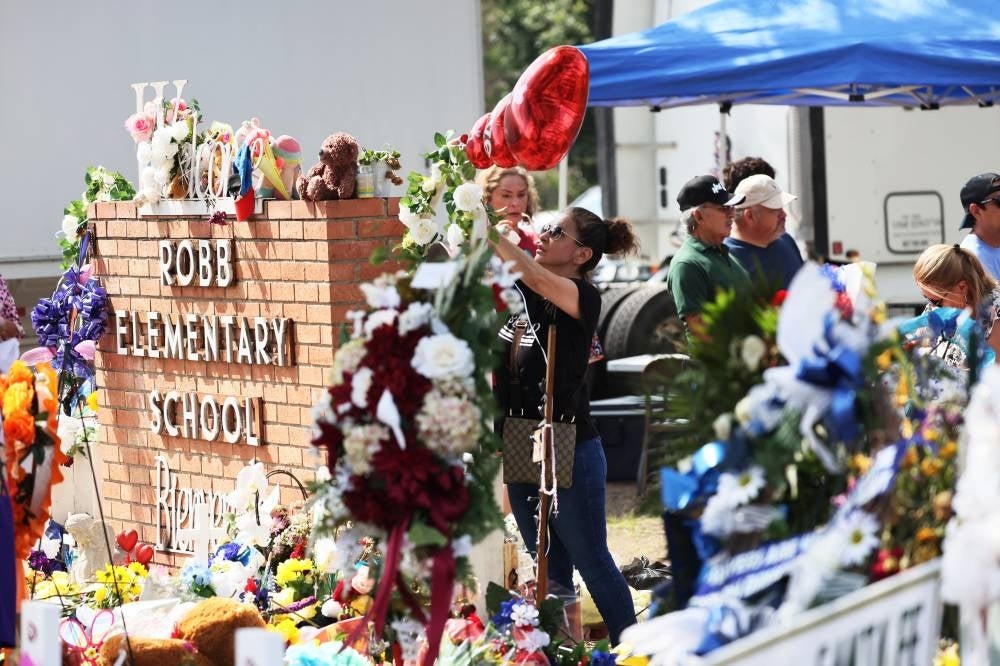 People visit a memorial for the 19 children and two adults killed on May 24 during a mass shooting at Robb Elementary School on May 30, 2022 in Uvalde, Texas. - AFP