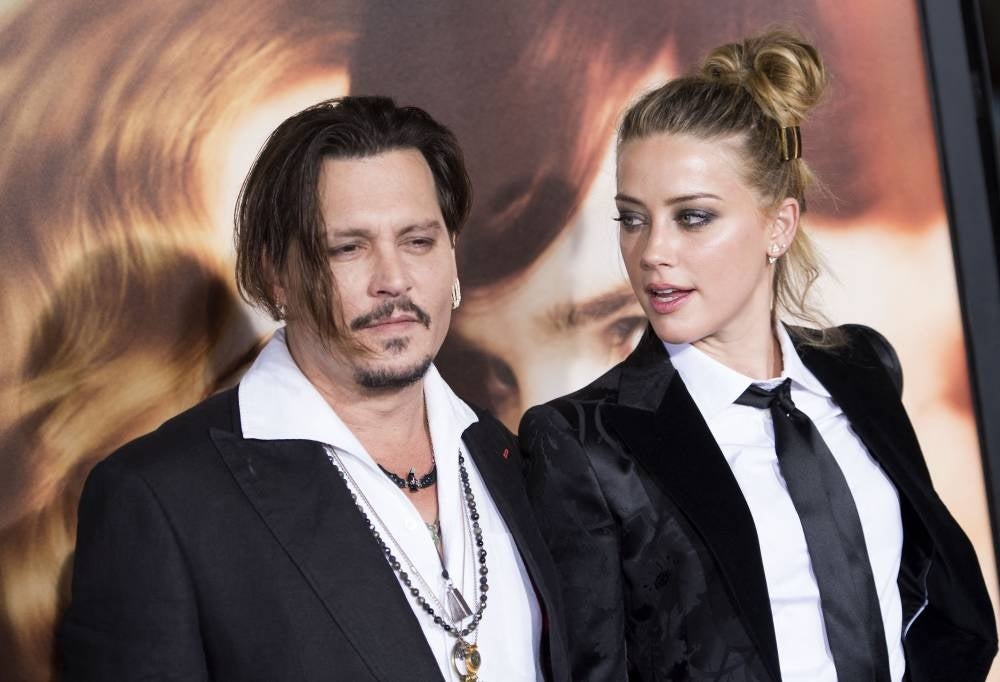 (FILES) Happier times? In this file photo taken on November 21, 2015 Actors Johnny Depp (L) and Amber Heard attend the Los Angeles Premiere of 