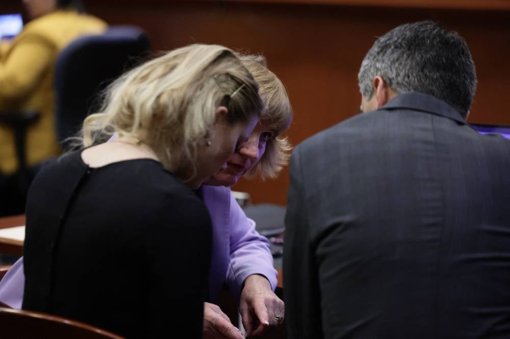 Attorney Elaine Bredehoft talks with her client US actress Amber Heard before the jury announces the verdict in the Depp v. Heard civil defamation trial at the Fairfax County Circuit Courthouse in Fairfax, Virginia, June 1, 2022. - A US jury on June 1, 2022 found Johnny Depp and Amber Heard defamed each other, but sided far more strongly with the "Pirates of the Caribbean" star following an intense libel trial involving bitterly contested allegations of sexual violence and domestic abuse. (Photo by EVELYN HOCKSTEIN / POOL / AFP)