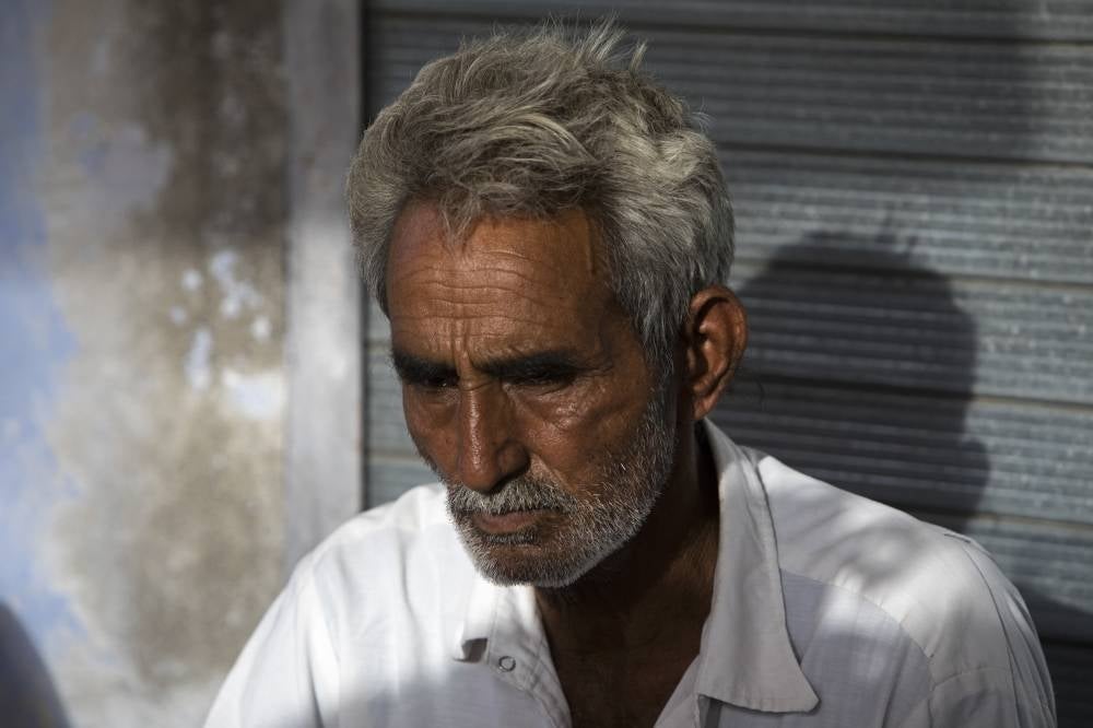 Farmer Sardar Meena mourns for his three married daughters and two grandchildren, who were found dead in a well in Dudu village on May 28, at the family home in Chhapya village of India's Rajasthan state on May 31, 2022. - AFP