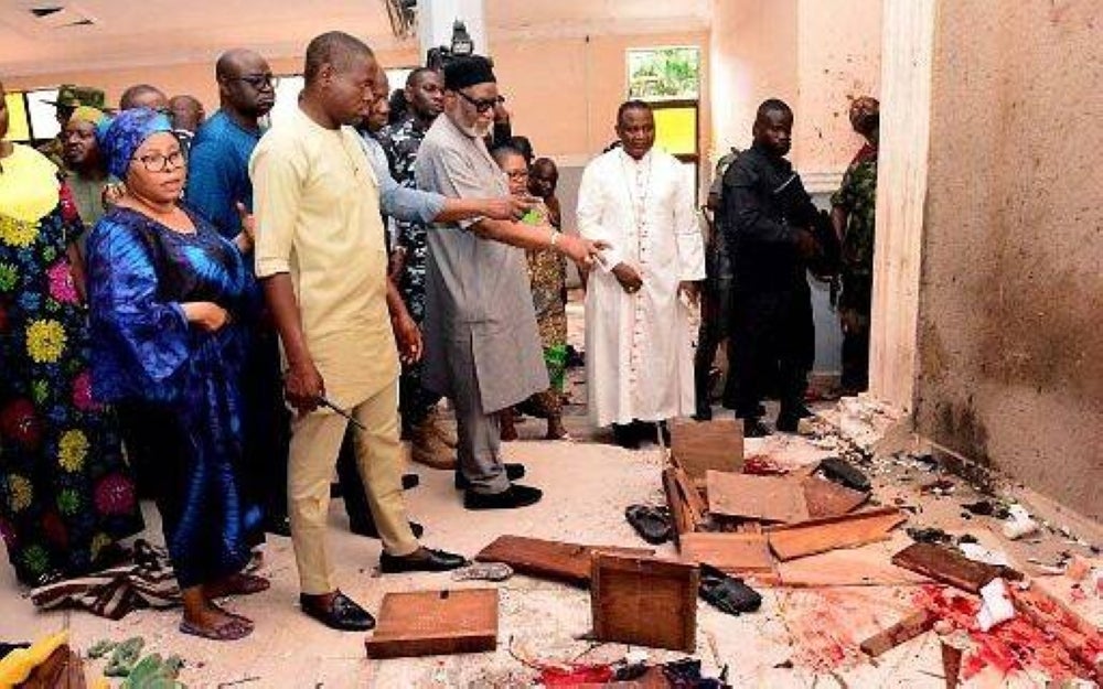 Ondo State Governor Rotimi Akeredolu (third left) points to the blood stained floor after an attack by gunmen at St. Francis Catholic Church in Owo town, southwest Nigeria, June 5, 2022. AFP pic 