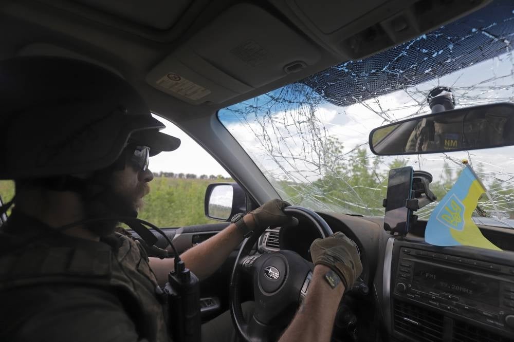 A Ukrainian servicemen drives a car near their position in Novoluhanske, Donetsk area, Ukraine, June 8, 2022. Russian troops on 24 February entered Ukrainian territory, starting a conflict that has provoked destruction and a humanitarian crisis. (EPA