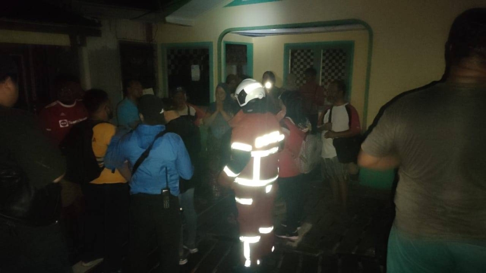 Firemen on scene in Kampung Lok Urai, Pulau Gaya, Kota Kinabalu.