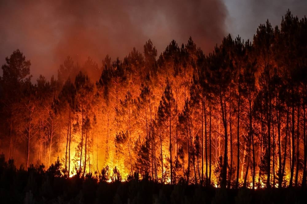 A forest fire in Louchats, south-western France on July 17, 2022. - (Photo by THIBAUD MORITZ / AFP)