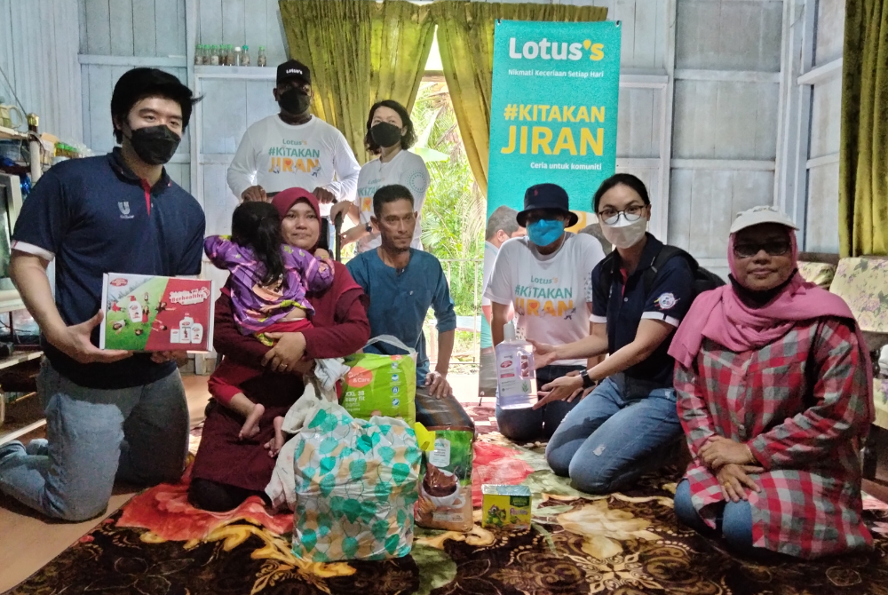 Lotus’s Kota Bharu Store General Manager, Koh Siuew Luan with the team from Lotus’s handing over donations to residents