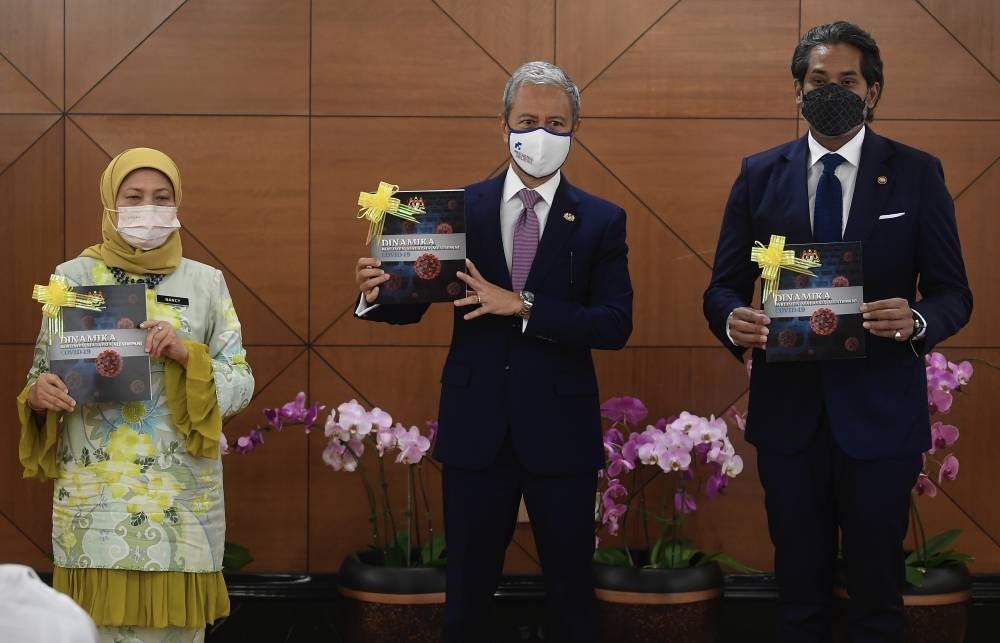 Dewan Rakyat Speaker Tan Sri Azhar Azizan Harun (middle), Arts and Culture Minister Datuk Seri Nancy Shukri (left) and Health Minister Khairy Jamaluddin during the launch of the "Dynamics of the Malaysian Parliament in the Face of Covid-19" book. - BERNAMA