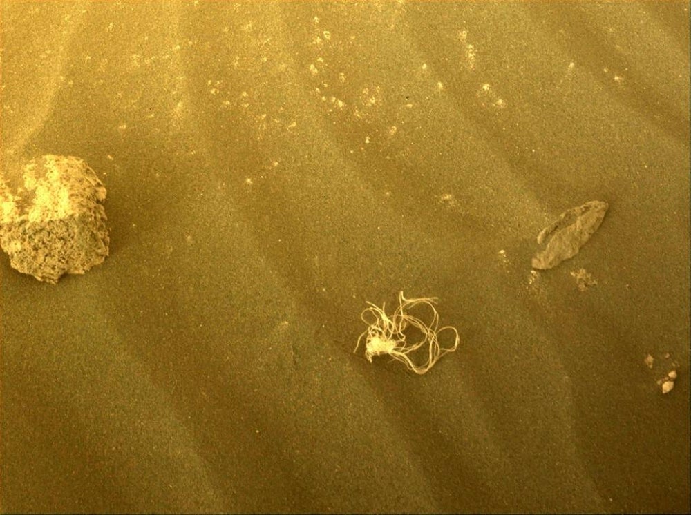 This image obtained from NASA and taken by the Mars Perseverance rover on July 12, 2022, show what appear to be string on the red planet. - Is it tumbleweed? A piece of fishing line? Spaghetti? A tangled object discovered by NASA's Mars Perseverance rover has intrigued space watchers, leaving some wondering about the quality of Italian dining on the Red Planet.
But the most plausible explanation is more prosaic: it's likely remnants of a component used to lower the robotic explorer to the Martian surface in February 2021. (Photo by Handout / NASA/JPL-Caltech / AFP) 