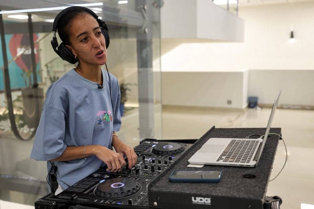 Saudi DJ Leen Naif plays at a university event in Saudia Arabia's Red Sea coastal city of Jeddah. Women DJs, an unthinkable phenomenon just a few years ago in the traditionally ultraconservative Saudi kingdom, are becoming a relatively common sight in its main cities. (Photo by Fayez Nureldine / AFP)