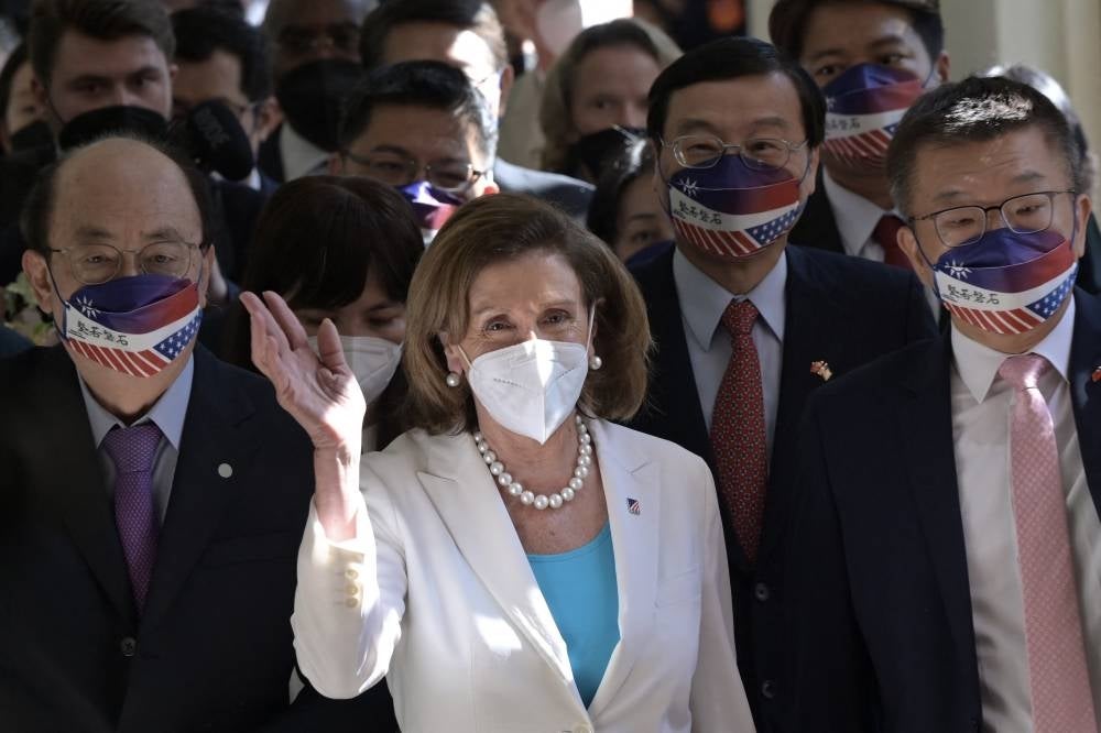 Visiting US House Speaker Nancy Pelosi (centre) waves to journalists during her arrival at the Parliament in Taipei on Aug 3, 2022. - (Photo by SAM YEH / AFP)