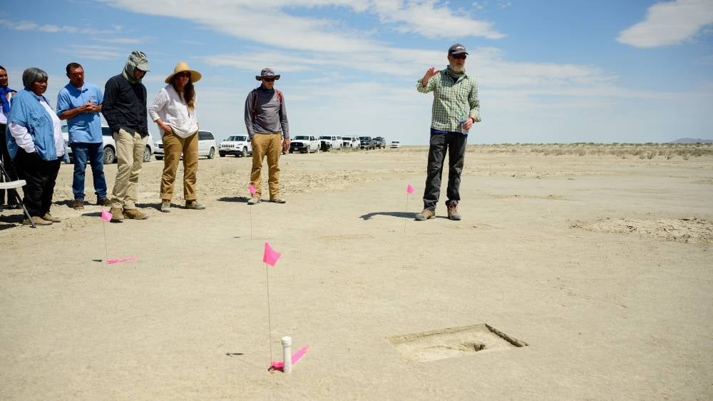 This image released by the US Air Force shows Daron Duke, from Far Western Anthropological Research Group, speaking with visitors about footprints discovered on an archaeological site marked with a pin flag on the Utah Test and Training Range, on July 18, 2022. Photo by R. Nial Bradshaw/AFP PHOTO